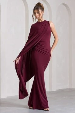 Unveil | Burgundy One-Sleeve Cape Maxi Dress 11 Unveil | Burgundy One-Sleeve Cape Maxi Dress -ENY Clothing Shop WB CL129803069 UnveilBurgundyOne SleeveCapeMaxiDress2
